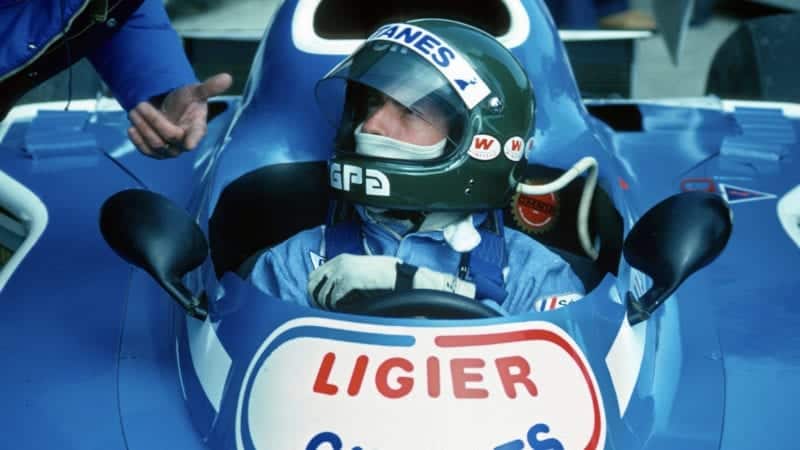 Jacques Laffite in the pis with his helmet on during the 1976 Spanish Grand Prix weekend at Jarama