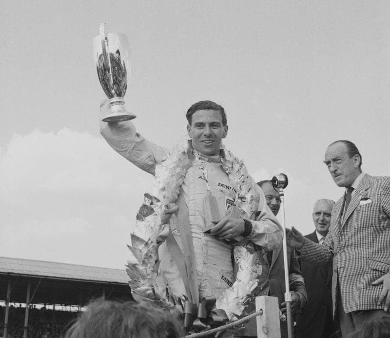 Jim Clark celebrates winning the British Grand Prix