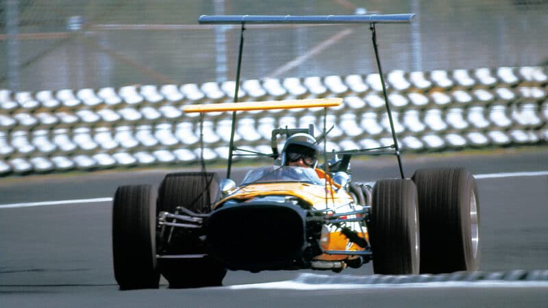 Joakim Bonnier (privateer McLaren-BRM with high wings) in the 1968 Mexican Grand Prix