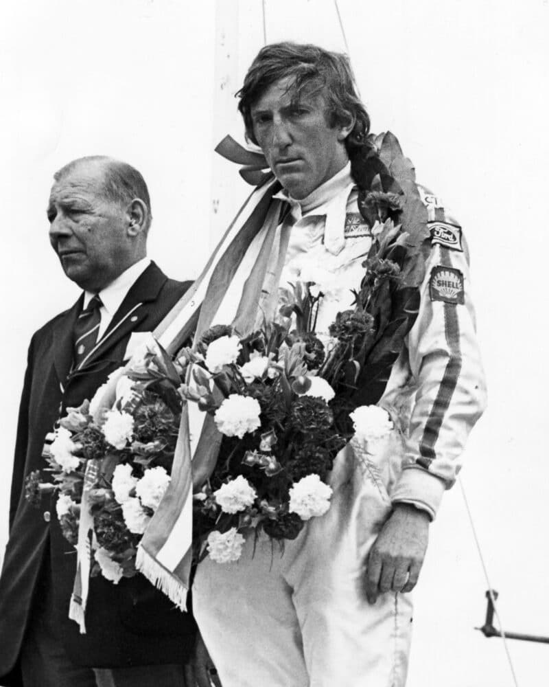 Jochen Rindt stands on the podium after the 1970 Dutch Grand Prix where Piers Courage was killed
