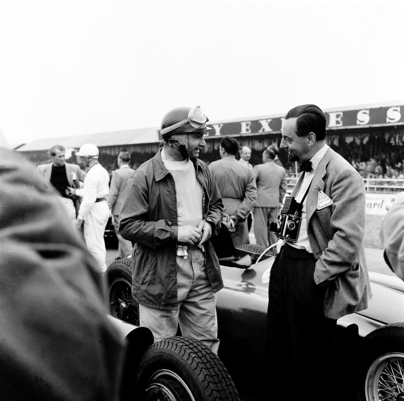 The British Grand Prix; Silverstone, July 14, 1956. Before the start of the race Juan Manuel Fangio, the best driver, chats with his friend Louis Klemantaski, the best motor racing photographer. Fangio went on to win. (Photo by Klemantaski Collection/Getty Images)