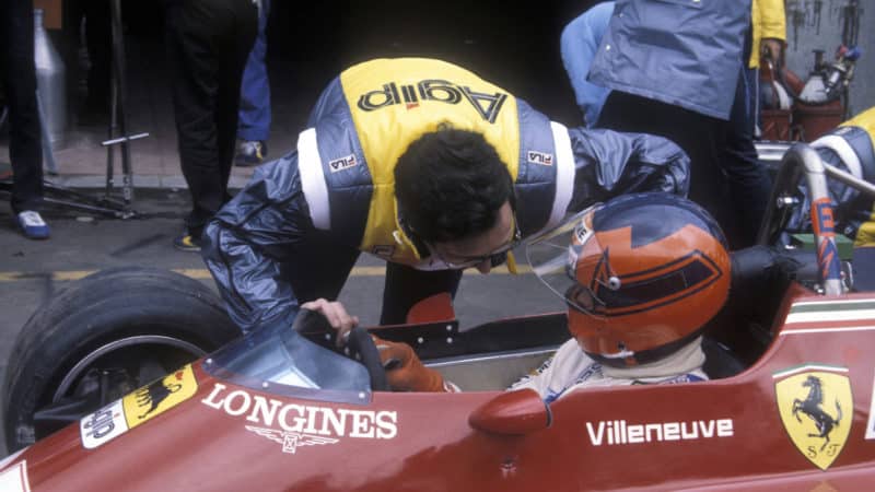 Mauro Forghieri leans in to GIlles Villeneuve's Ferrari at Zolder during practice for the 1982 Dutch Grand Prix