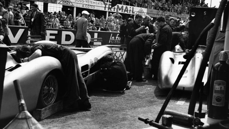 Pit mechanics work on the Mercedes-Benz racecars which are competing well in the French Grand Prix. (Photo by © Hulton-Deutsch Collection/CORBIS/Corbis via Getty Images)