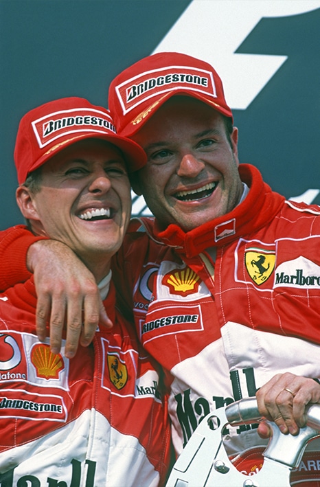 Michael Schumacher and Rubens Barrichello celebrate on the podium after 1-2 finish in the 2002 F1 Hungarian Grand Prix