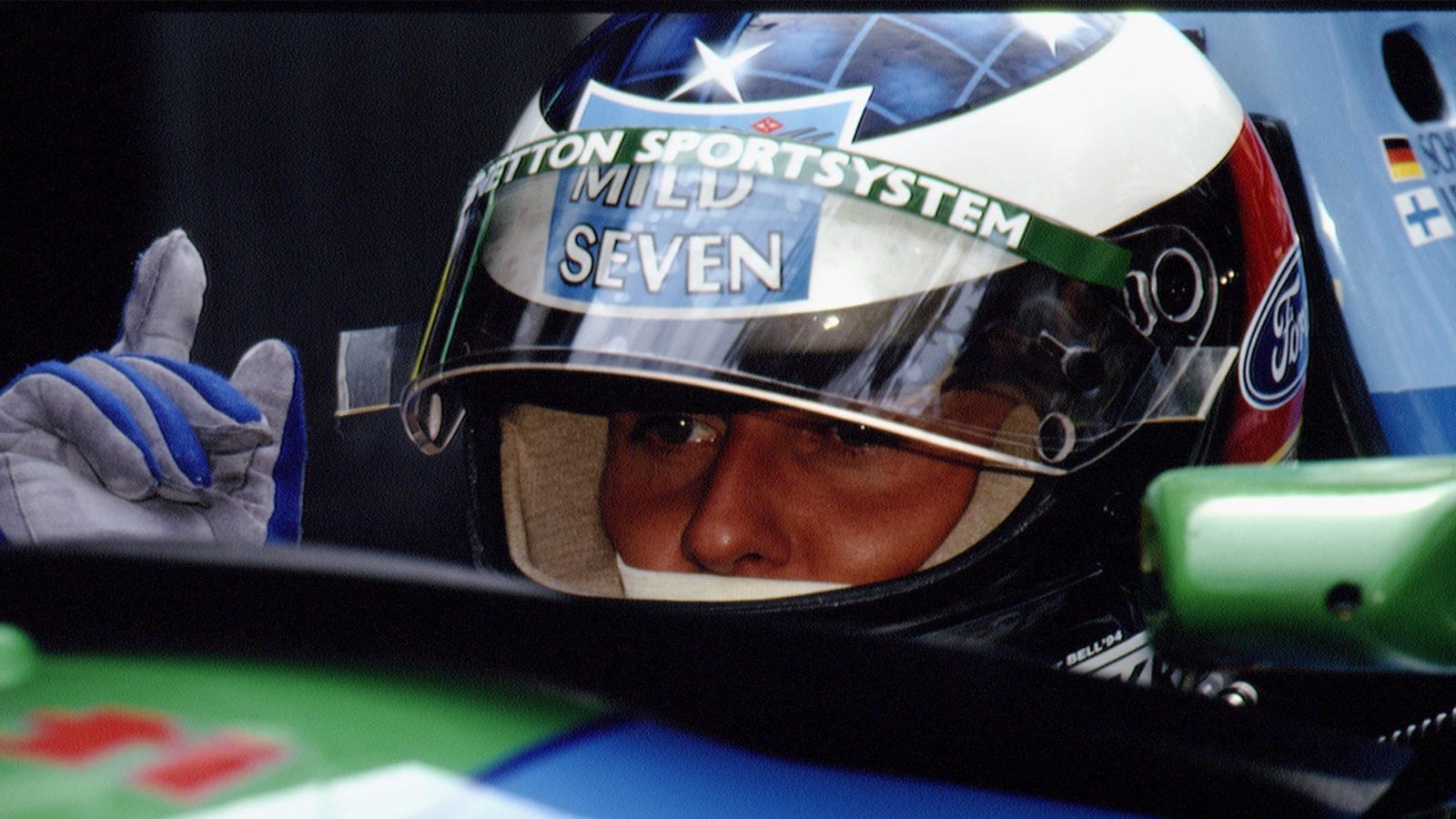 Michael Schumacher peers out from behind his helmet in the 1994 Benetton Ford