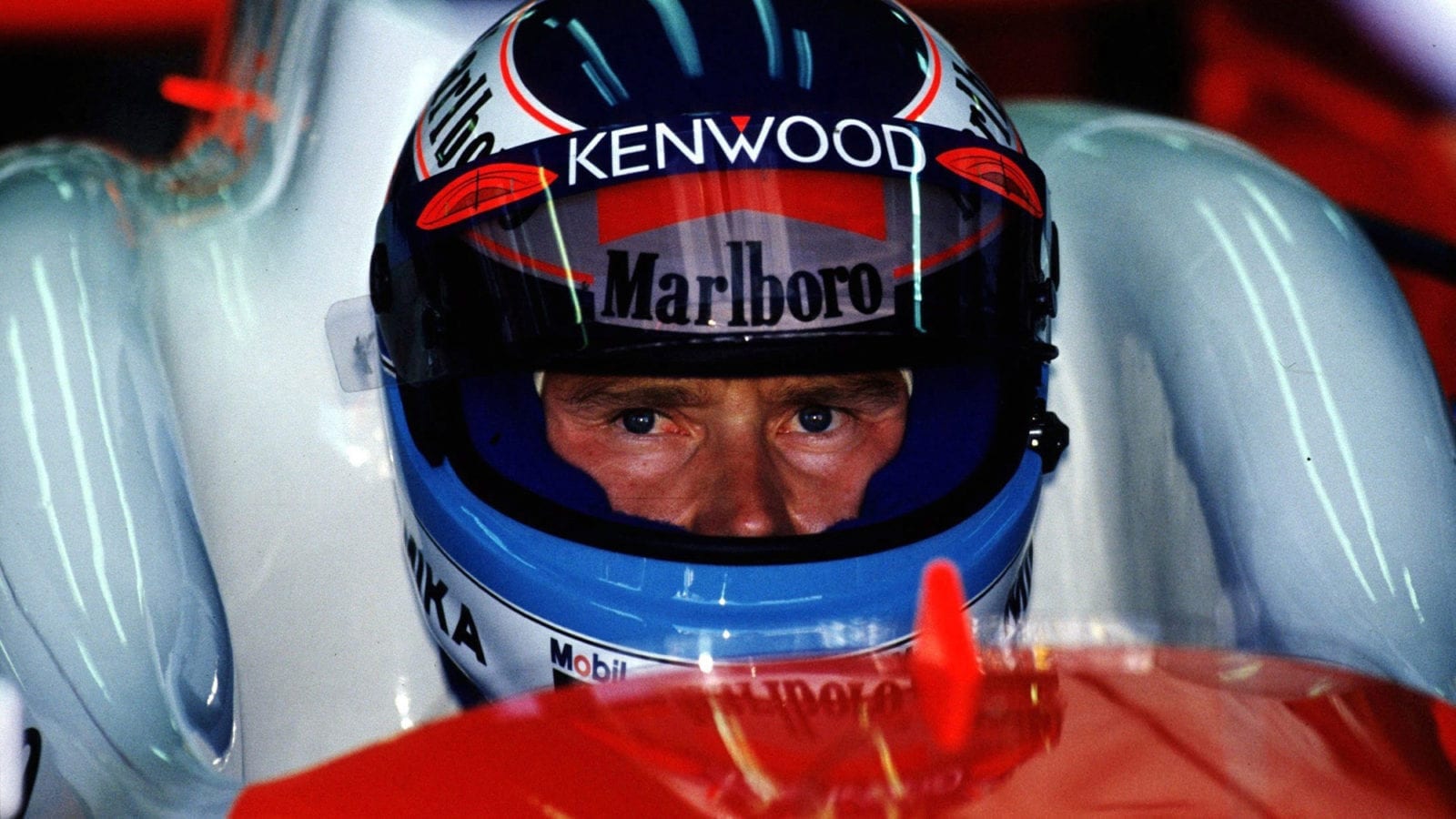 Mika Hakkinen peers through his helmet while sitting in his McLAren during the 1996 F1 Australian Grand Prix weekend at Melbourne