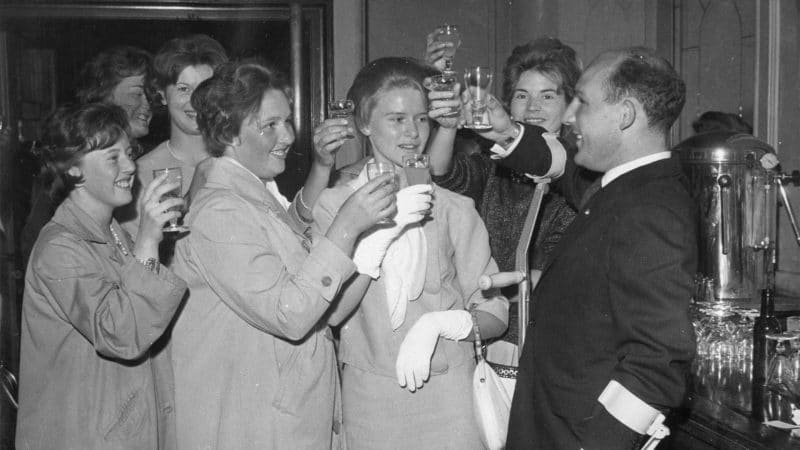 30th June 1962: English motor racing driver Stirling Moss toasts the nurses who treated him after his crash at Goodwood, in the bar at the Criterion Theatare, London. (Photo by Keystone/Getty Images)