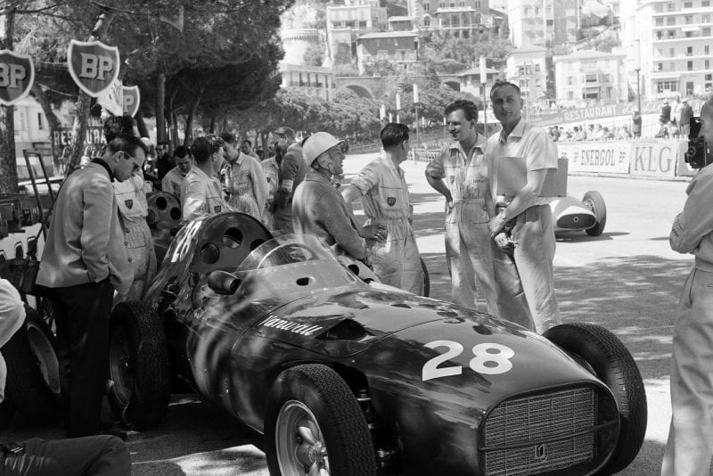 STirling MOss leans on his Vanwall during the 1958 Grand Prix practice.