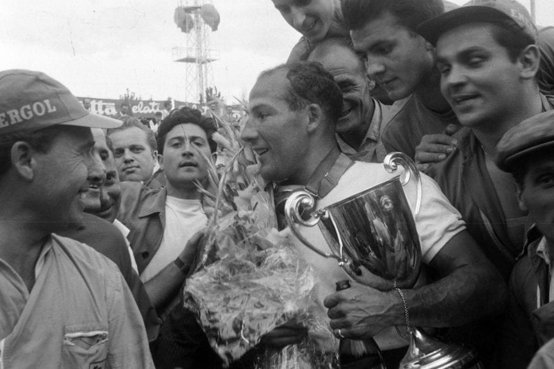 Stirling Moss celebrates victory at the 1956 Italian Grand Prix, Monza