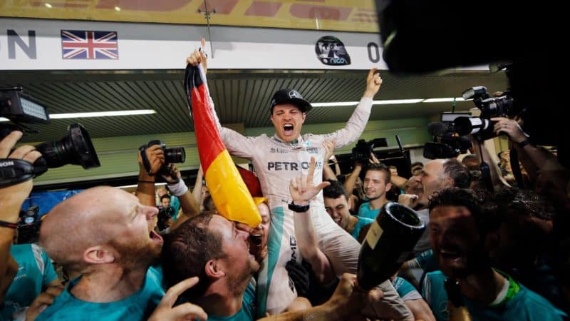 Nico Rosberg held up by mechanics as he celebrates becoming F1 world champion