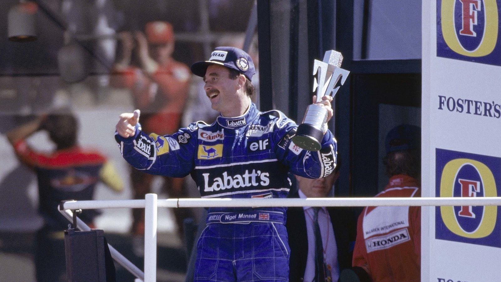 Nigel-Mansell-celebrates-victory-on-the-podium-at-Silverstone-after-the-1991-British-Grand-Prix
