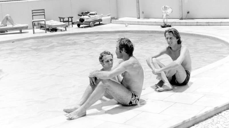 Niki Lauda in swimming pool while Clay Regazzoni and Luca Di Montezemolo sit on the side