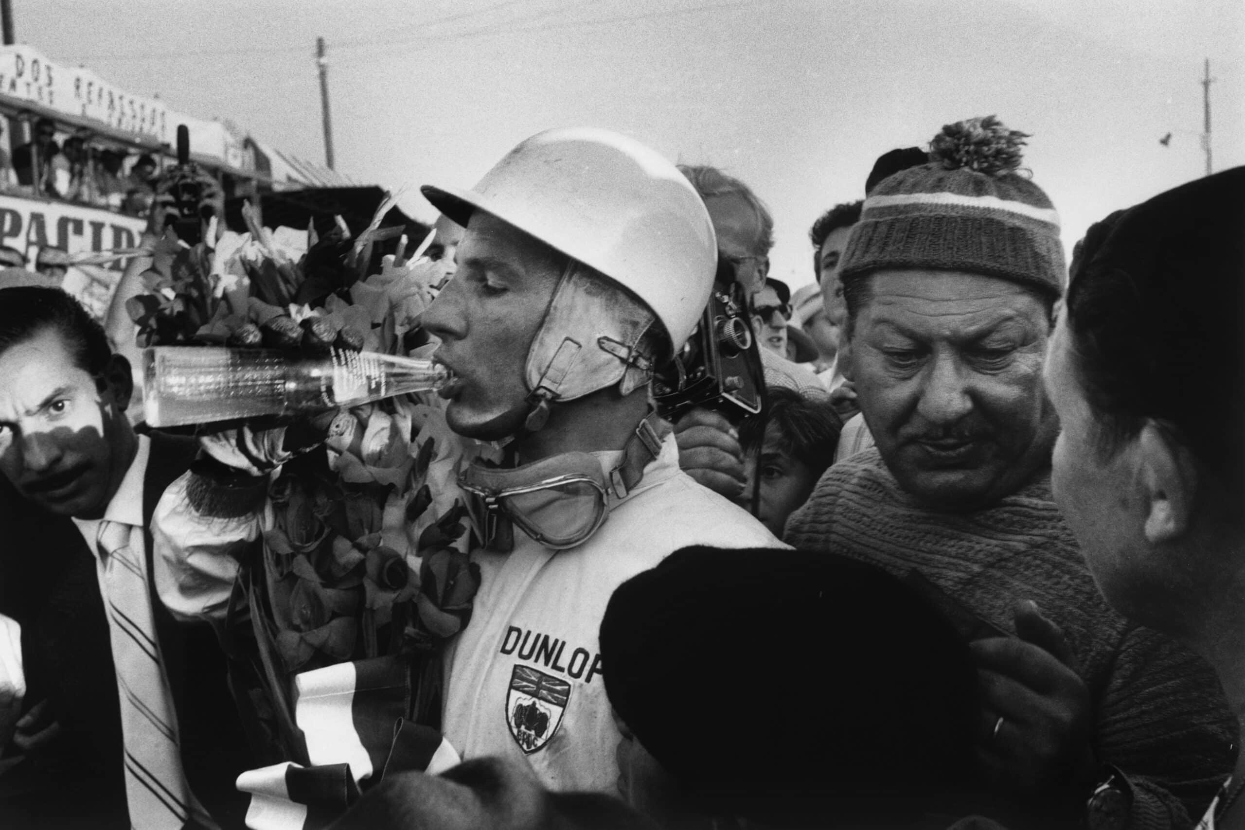 Stirling Moss celebrates with after winning.