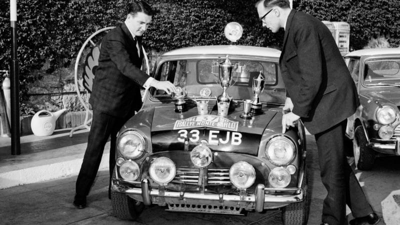 Paddy Hopkirk and Henry Liddon with 1964 Monte Carlo Rally trophies on their Mini Cooper