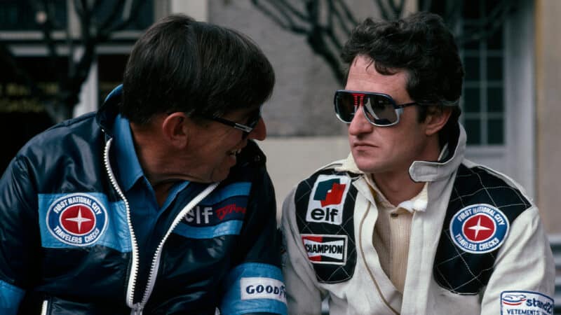 Patrick Depailler sits next to Ken Tyrrell