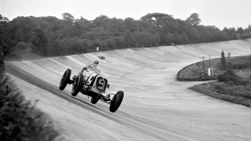 Prince Bira bounces over the brooklands banking in his 3-litree Maserati at the 1938 JCC 200 mile race
