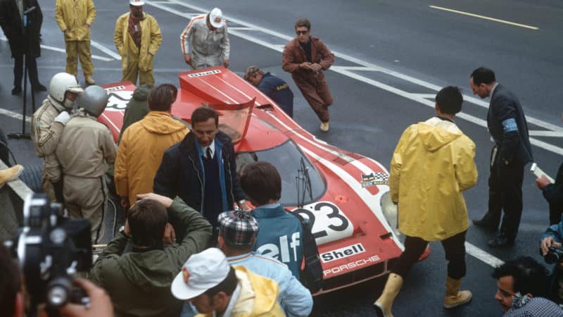 Richard Attwood and Hans Herrmann talk in the pits at Le Mans 1970