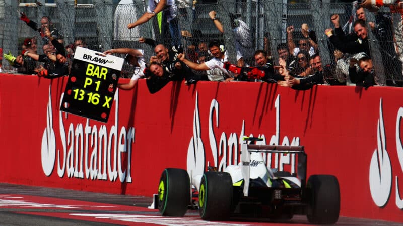 Rubens Barrichello drives past cheering Brawn pitwall as he wins the 2009 F1 Italian Grand Prix