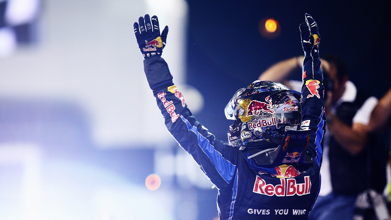 Sebastian Vettel holds his arms up after the 2010 Abu Dhabi Grand Prix