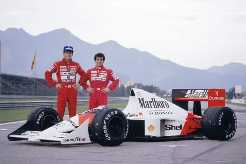 Ayrton Senna and Alain Prost stand next to their McLaren