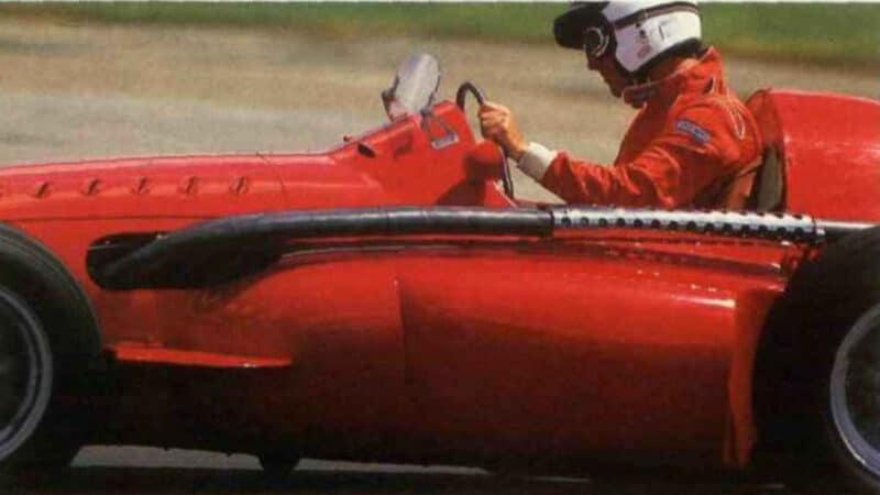 Side view of Ferrari 555 F1 car on track