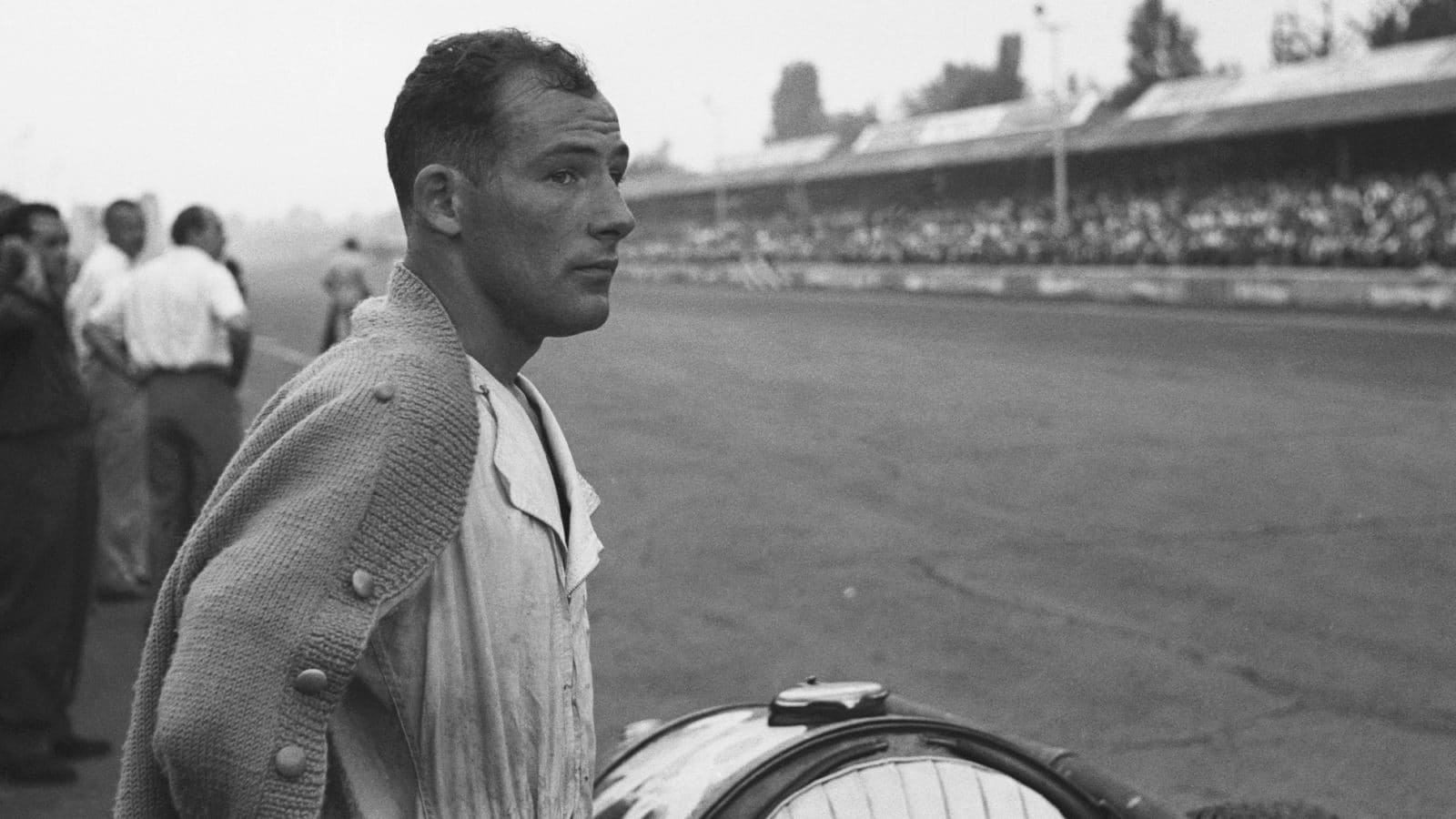 Stirling Moss watches from the side of the track at the 1954 Italian Grand Prix