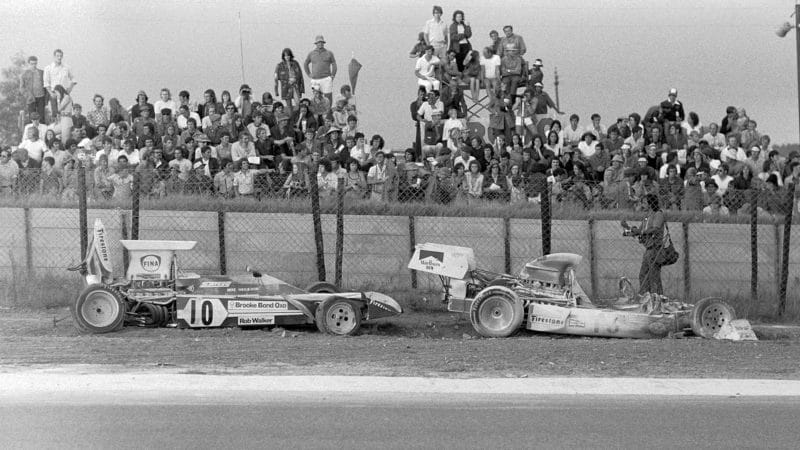 Surtees of Mike Hailwood behind the burned wreckage of Clay Regazzoni BRM at the 1973 South African Grand Prix