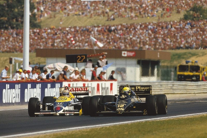Ayrton Senna (Lotus 98T Renault) overtakes Nigel Mansell (Williams FW11 Honda). They finished in 2nd and 3rd positions respectively.