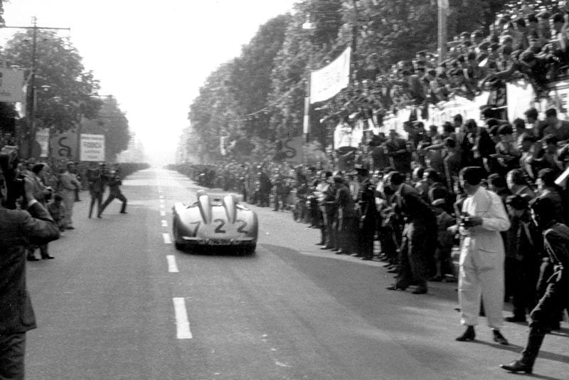 The Moss-Jenkinson Mercedes races past spectators at 1955 Mille Miglia Italy