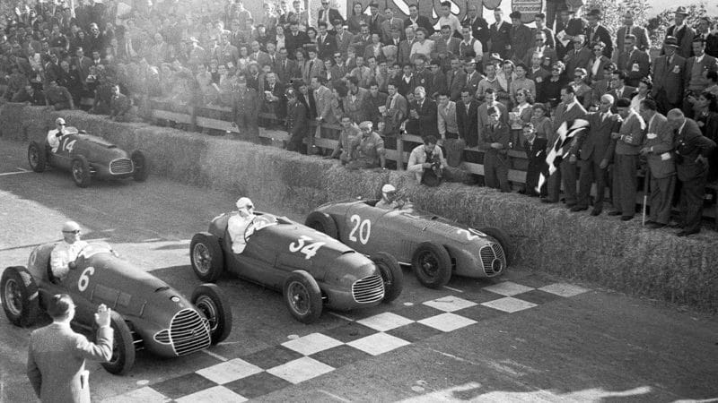 The-starting-flag-falls-on-the-road-above-the-city-with-two-Ferraris-and-a-Maserati-on-the-front-row-of-the-Circuito-del-Garda,-Salo,-24th-October-1948.-Car-6-is-an-early-Ferrari-125GP-driven-by-Nino-Farina