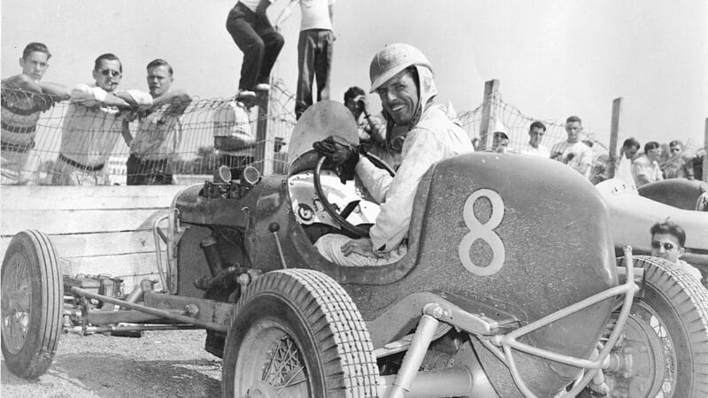 This driver is all smiles for the photographer as he gets ready for a late-1930s Sprint Car race