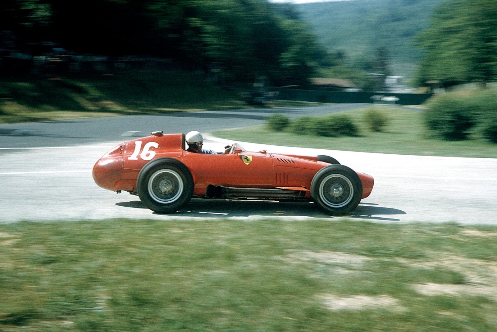 Maurice Trintignant (Lancia-Ferrari 801) takes a corner at the 1957 French Grand Prix, Rouen.