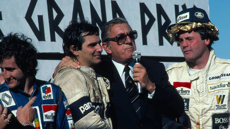 Piquet tries not to fall over, supported by FIA president Jean-Marie Balestre, with newly-laurelled race-winner Alan Jones to their right Caesars Palace GP Las Vegas 1981