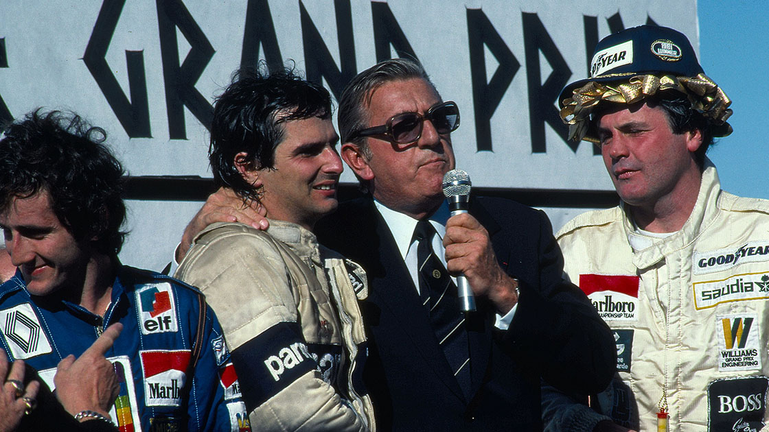 Piquet tries not to fall over, supported by FIA president Jean-Marie Balestre, with newly-laurelled race-winner Alan Jones to their right Caesars Palace GP Las Vegas 1981