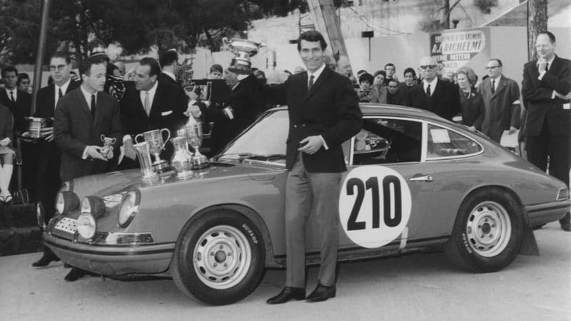 Vic Elford of Great Britain holds aloft the trophy as he stands beside the #210 Porsche 911T after winng the Monte Carlo Rally on 25 Jan 1968 in the Principality of Monaco in Monte Carlo, Monaco. (Photo by Keystone/Hulton Archive/Getty Images).