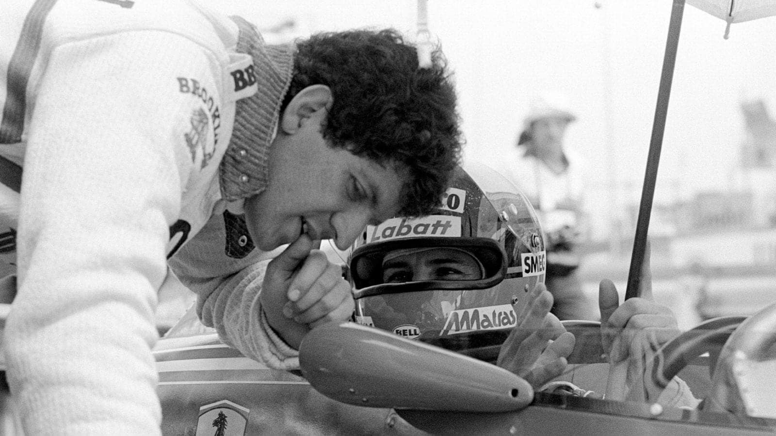Jody Scheckter leans over his Ferrari team mate Gilles Villeneuve to discuss the set-up during a practice session for the South African Grand Prix at Kyalami, 3rd March 1979. Villeneuve won and Scheckter came home second. (Photo by Klemantaski Collection/Getty Images)