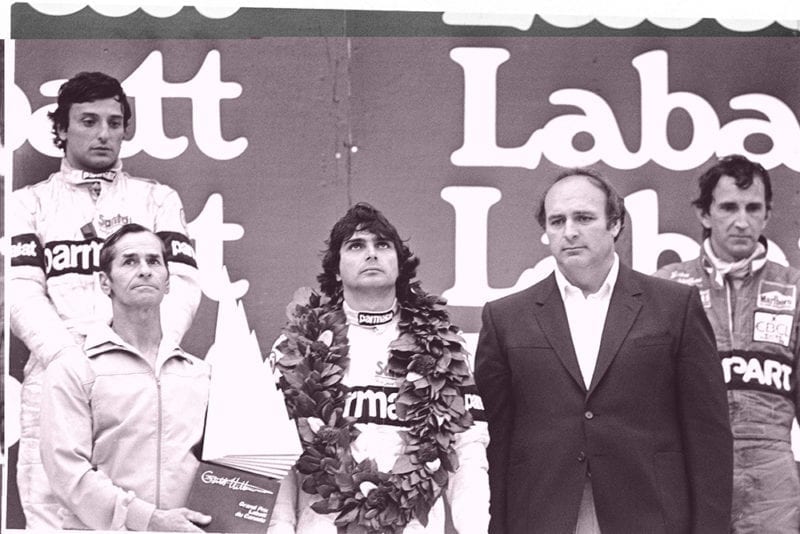 Nelson Piquet, 1st position, Riccardo Patrese, 2nd position and John Watson, 3rd position on the podium with Gilles Villeneuve father, Seville, holding the winners trophy.