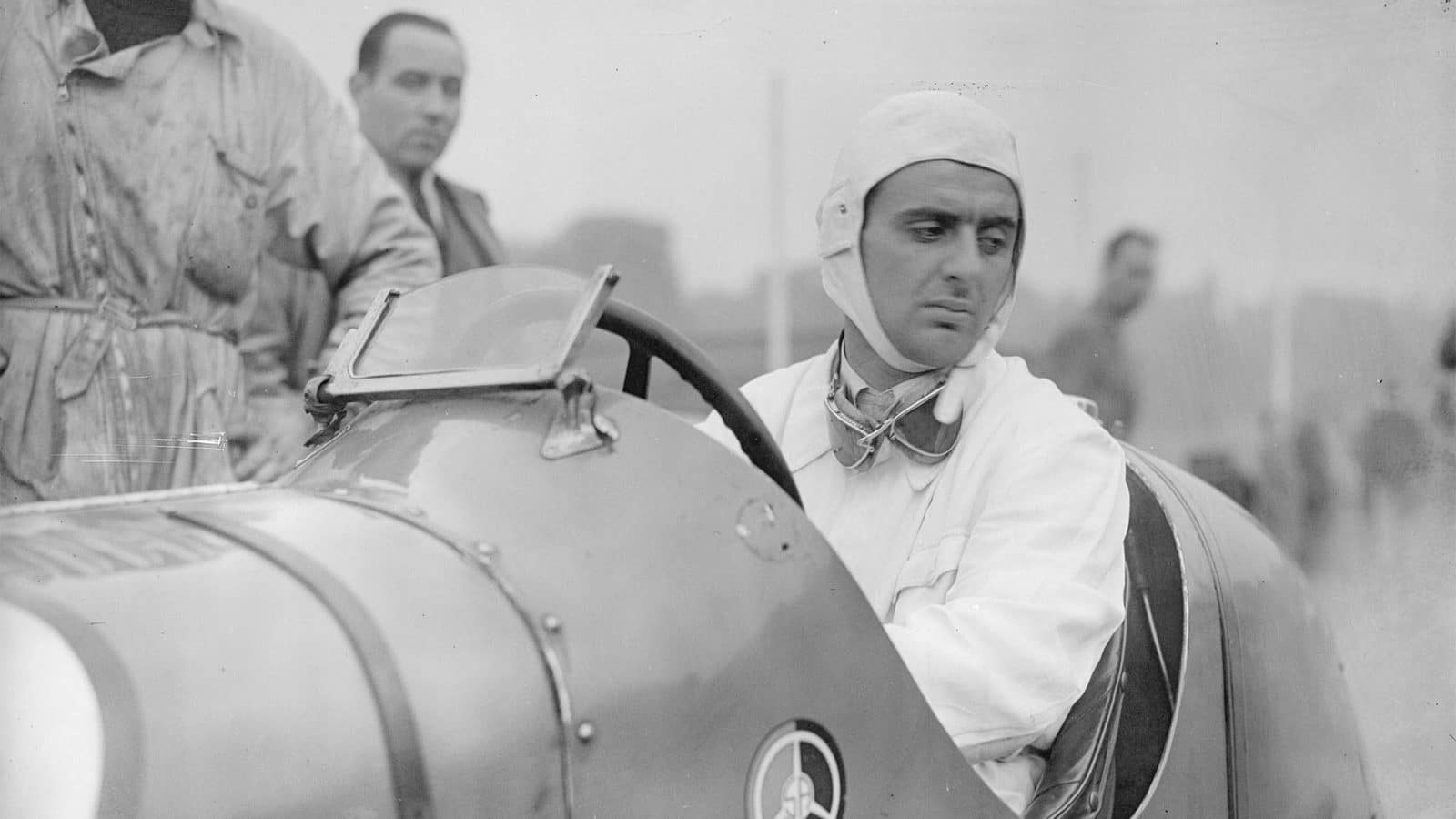 Italian racing driver Luigi Villoresi (1909 - 1997) sits in his Maserati whilst preparations continue for Britain's first international car race at Crystal Palace. (Photo by David Savill/Getty Images)