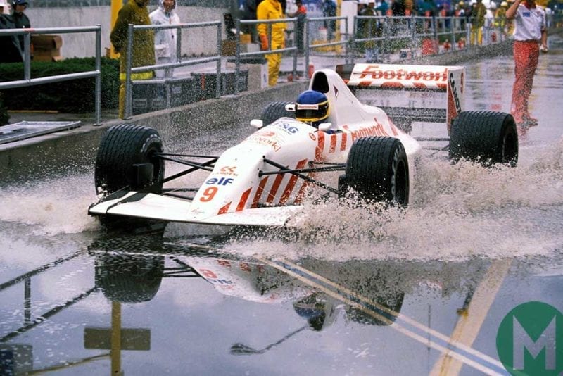 Michele Alboreto splashes through the wet pitlane in Phoenix at the US Grand Prix