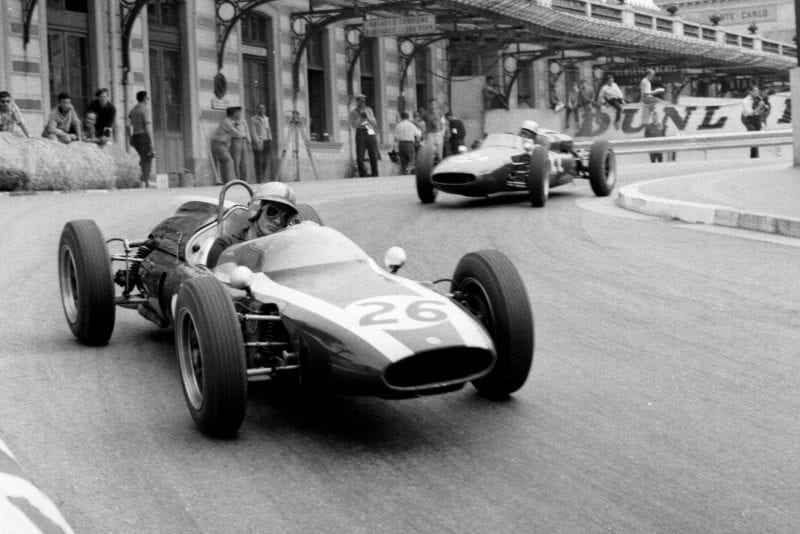 Bruce McLaren in a Cooper T55 Climax leads John Surtees at the wheel of a Cooper T53 Climax out of Station Hairpin.