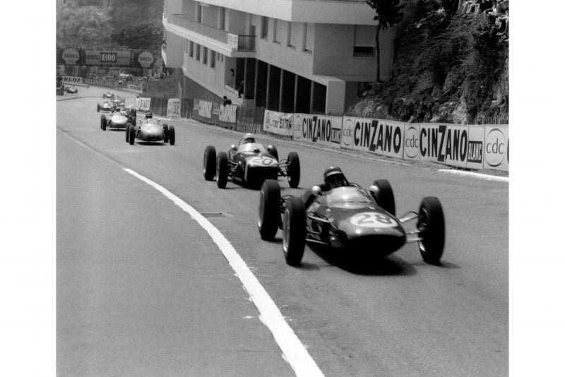 Jim Clark in a Lotus 21-Climax leads Stirling Moss driving a Lotus 18-Climax.