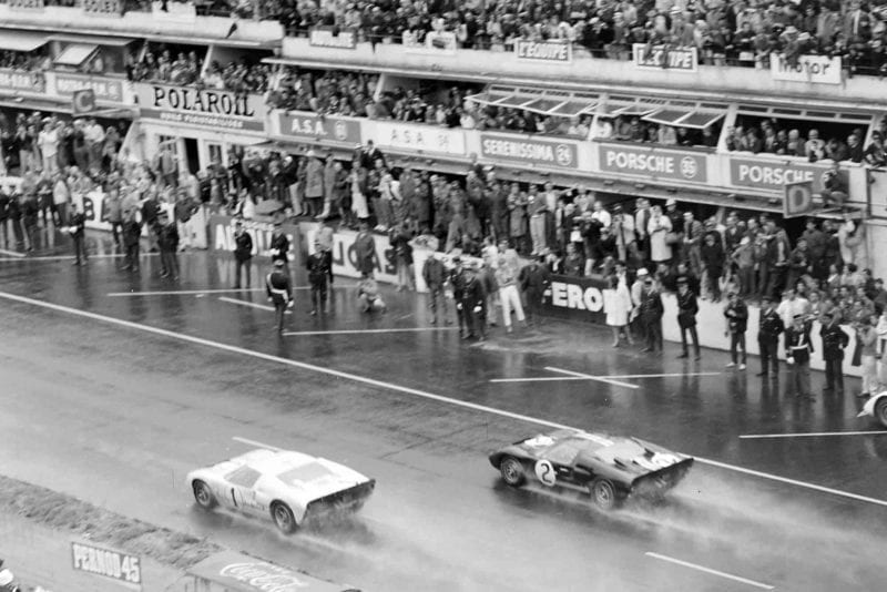 The two Ford GT40s approach the line