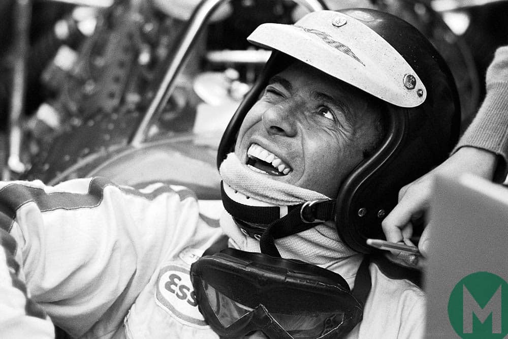 Jim Clark smiles up from the cockpit of his Lotus Formula One car