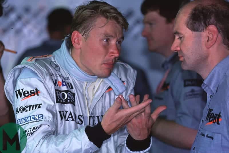 Mika Hakkinen confers with McLaren-Mercedes technical director Adrian Newey