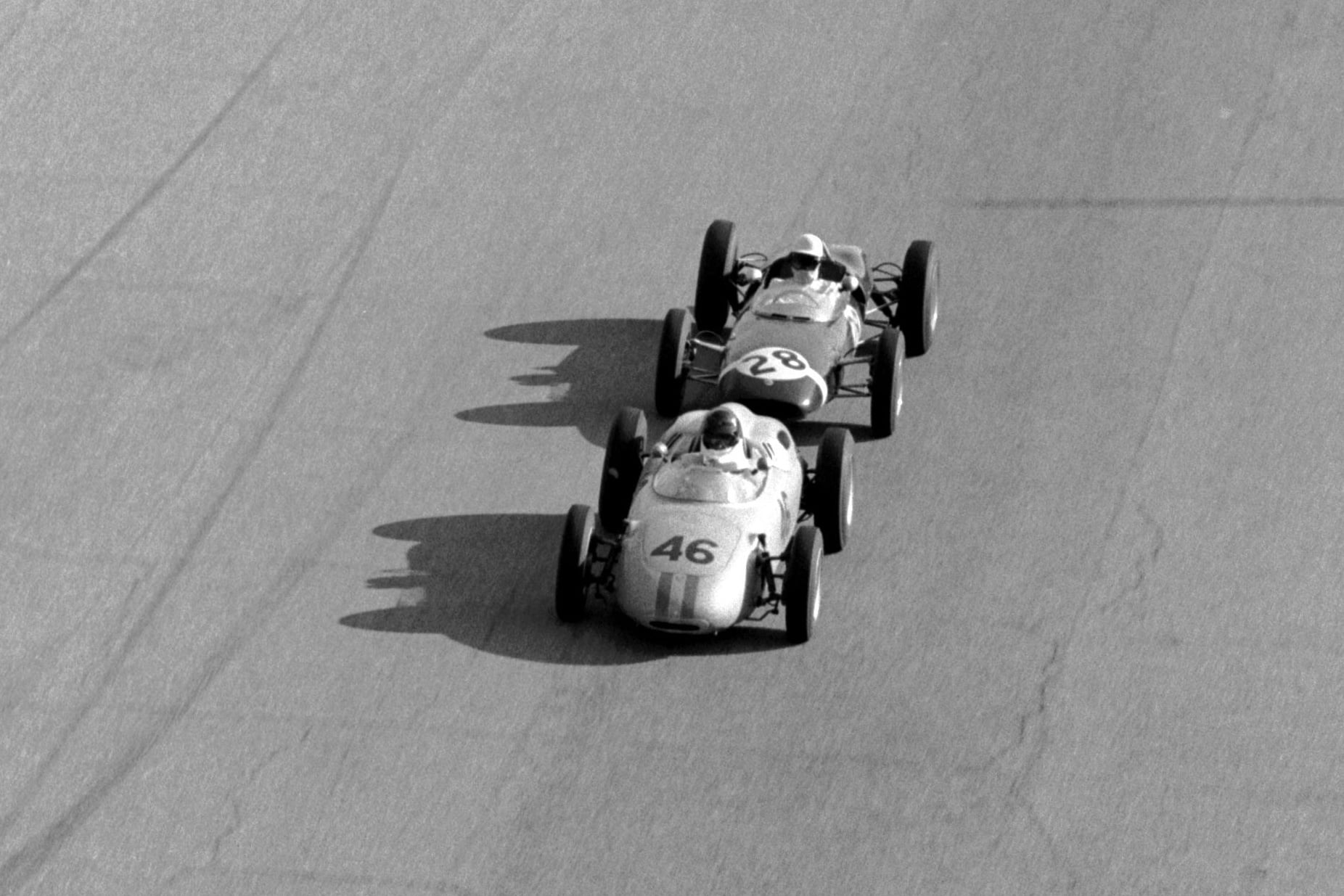 Dan Gurney in a Porsche 718 leads Stirling Moss.