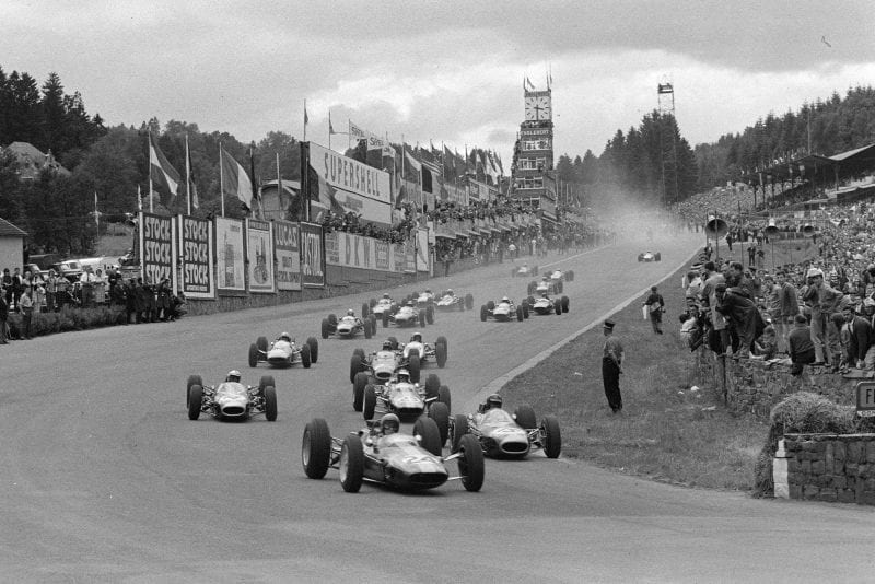 Peter Arundell, Lotus 25 Climax, leads into Eau Rouge at the start.