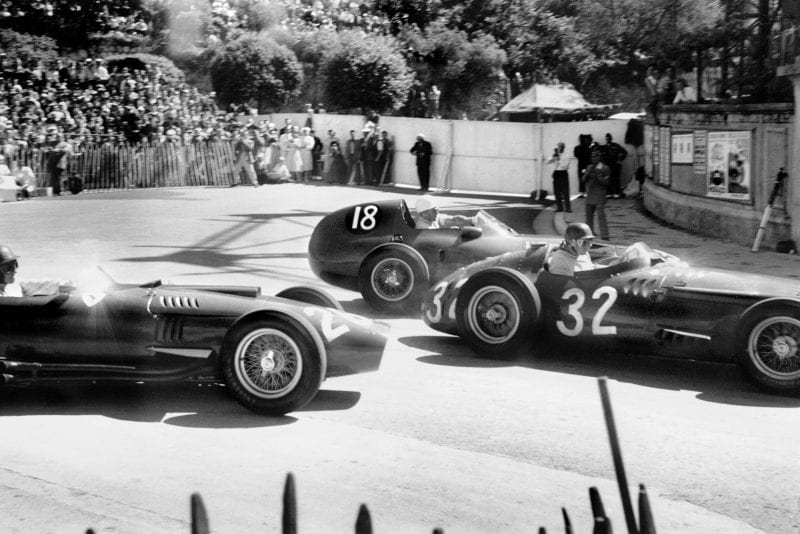 an Manuel Fangio (Maserati 250F), 1st position, leads Stirling Moss (Vanwall VW3), retired and Peter Collins (Lancia-Ferrari D50), retired, at the start of the 1957 Monaco Grand Prix.
