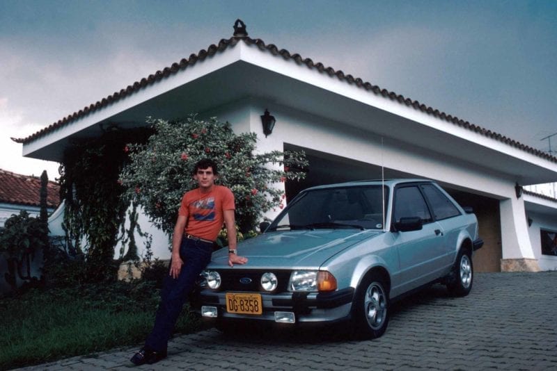 Ayrton Senna with his Ford Escort XR3 outside his family home in Brazil