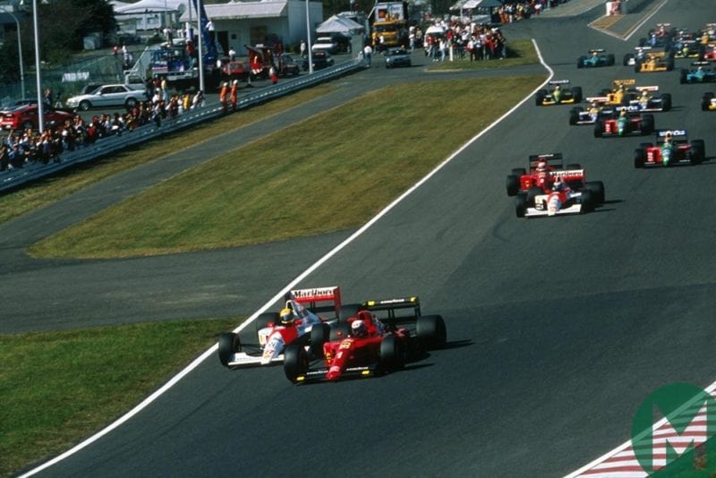 Ayrton Senna and Alain Prost head into the first corner at the 1990 Japanese Grand Prix