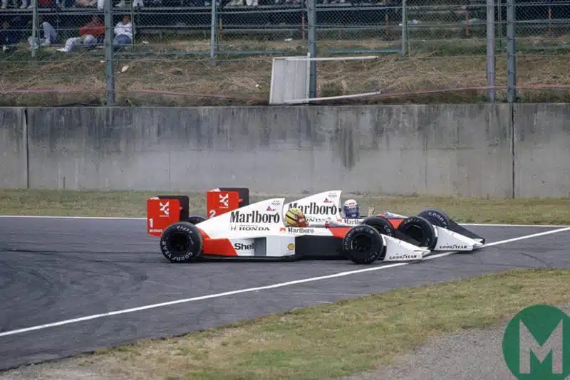 Ayrton Senna and Alain Prost crash their McLaren-Hondas into one another at the 1989 Japanese Gran Prix